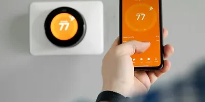 Man uses a mobile phone with smart home app in modern living room
